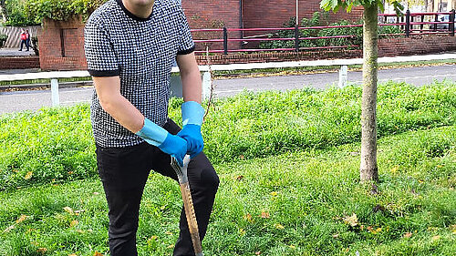 Cllr Gary Busuttil planting a tree.